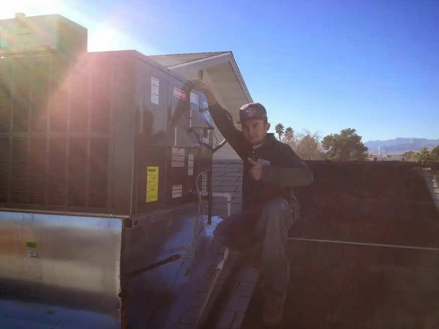 HVAC technician performing AC Tune-Up on a rooftop unit in Great Barrington